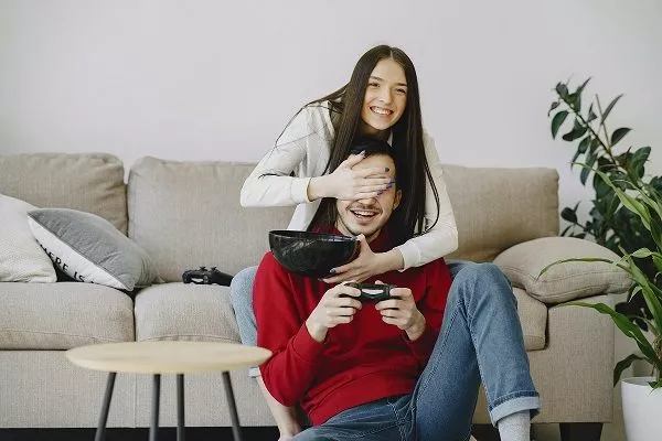 younger couple playing video games Image